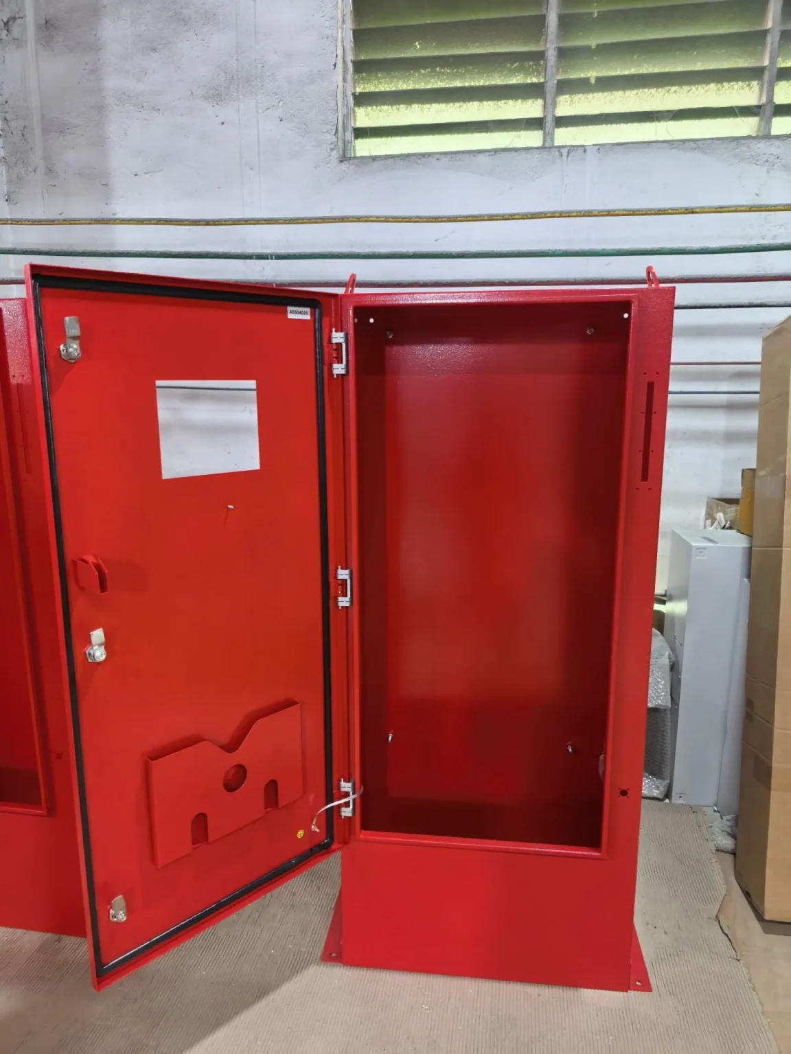 Open red electrical enclosure with inner door - Large Control and Power Distribution System for Smart Farm in Argentina - E-Abel - E-Abel - Knowledge Hub - E-Abel - E-Abel Boîtier électrique rouge ouvert avec porte intérieure